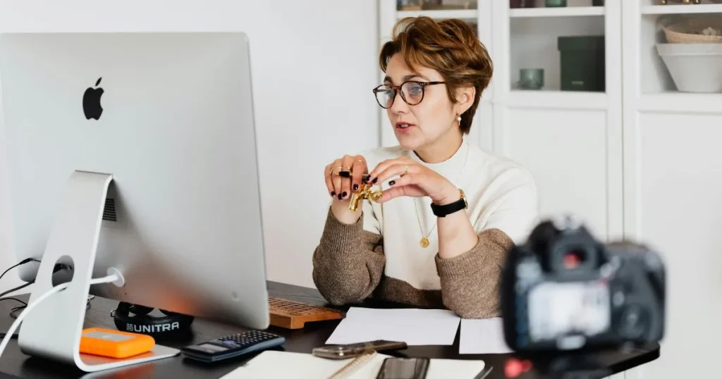 Business coach on video call conducting online session at desk